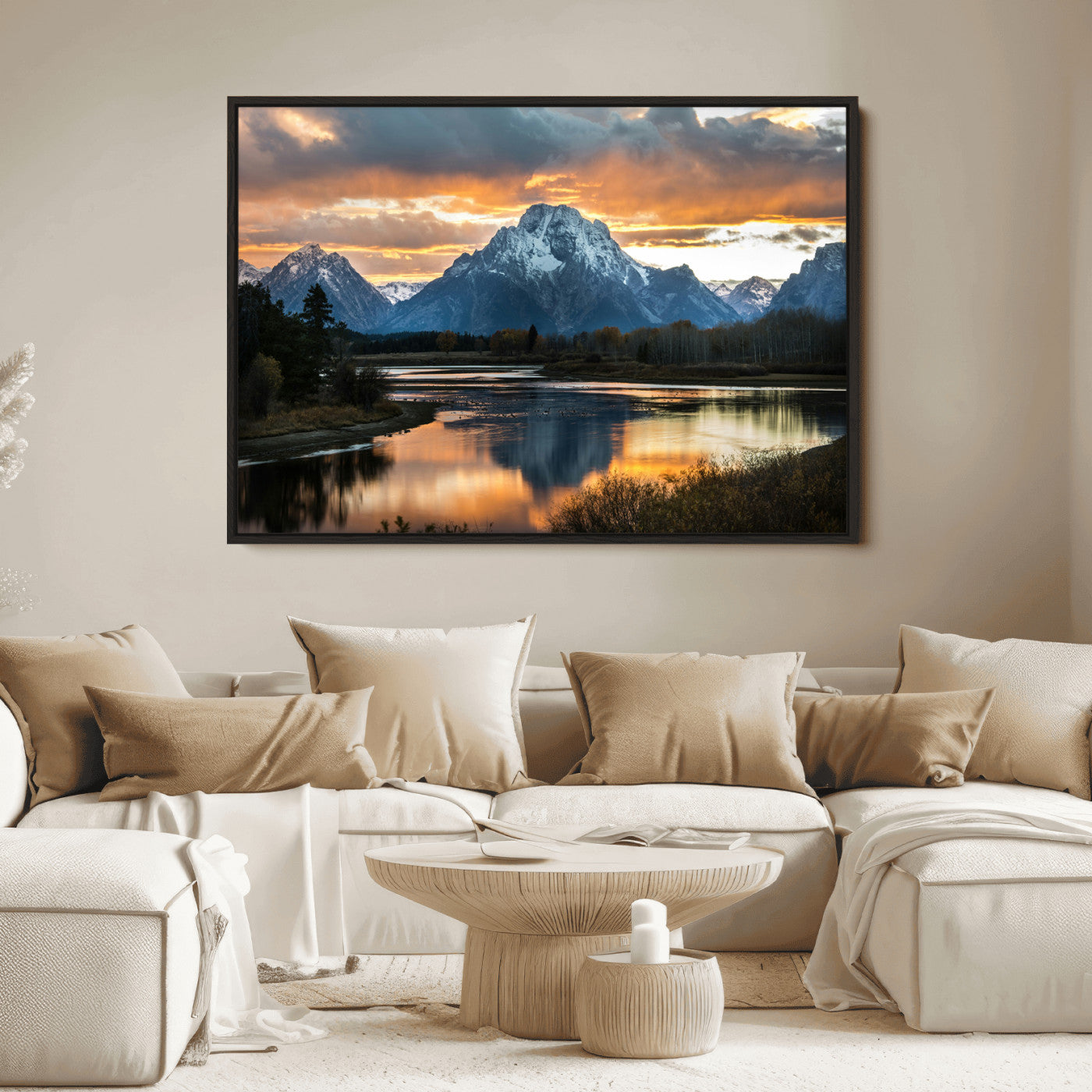 Snow-capped mountains reflecting in a calm lake at sunset, with a dramatic golden sky creating a breathtaking wilderness scene.