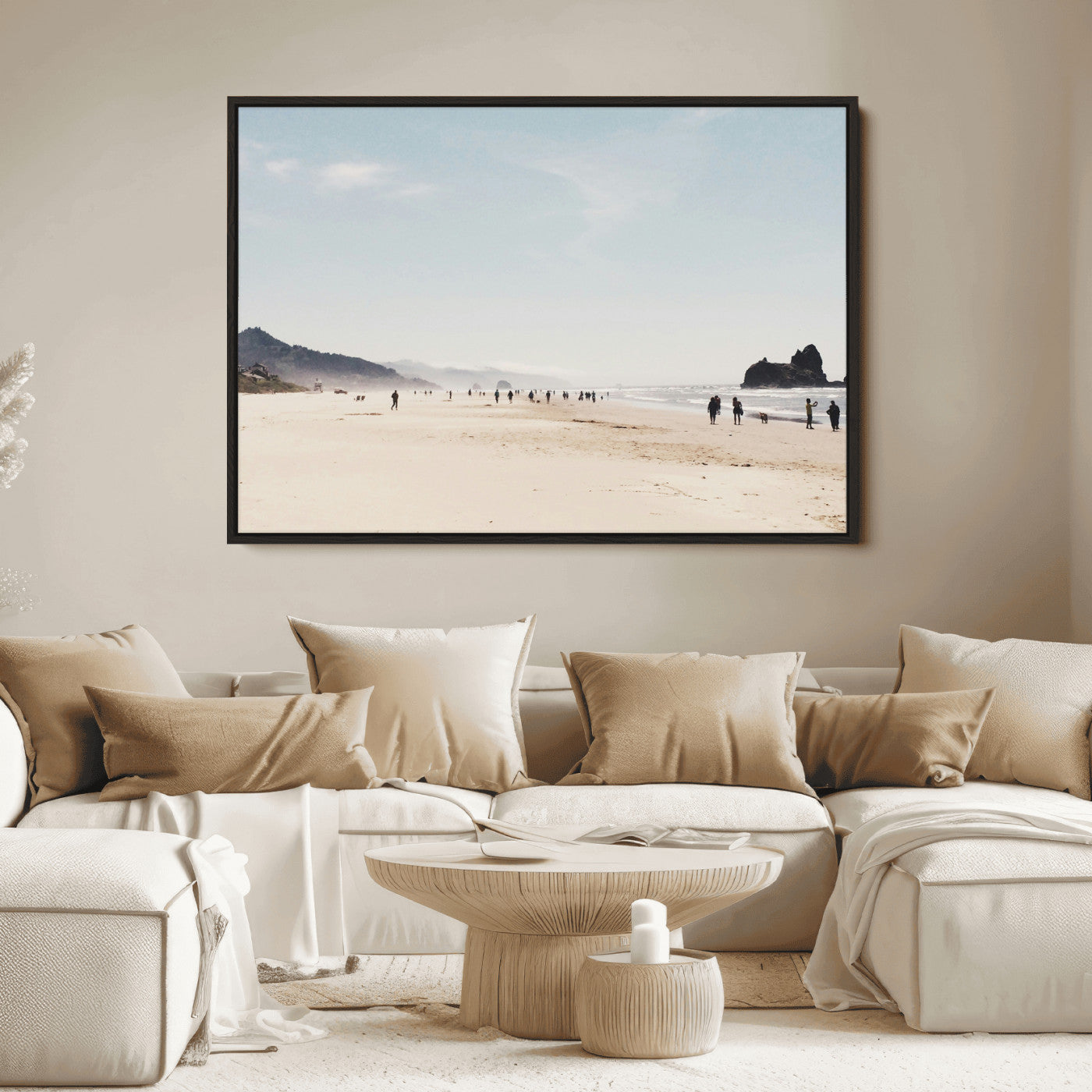 A serene beach with soft sand, misty mountains, and scattered people walking along the shoreline, creating a peaceful coastal landscape.