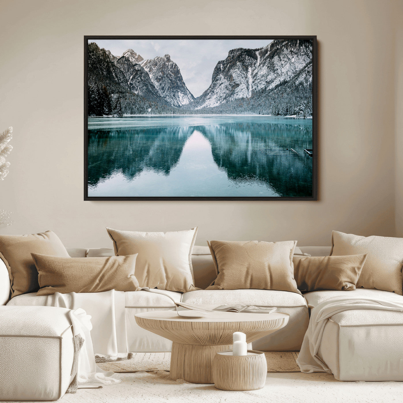 Crystal-clear alpine lake reflecting snow-covered mountains, surrounded by evergreen trees, creating a serene and tranquil winter landscape.