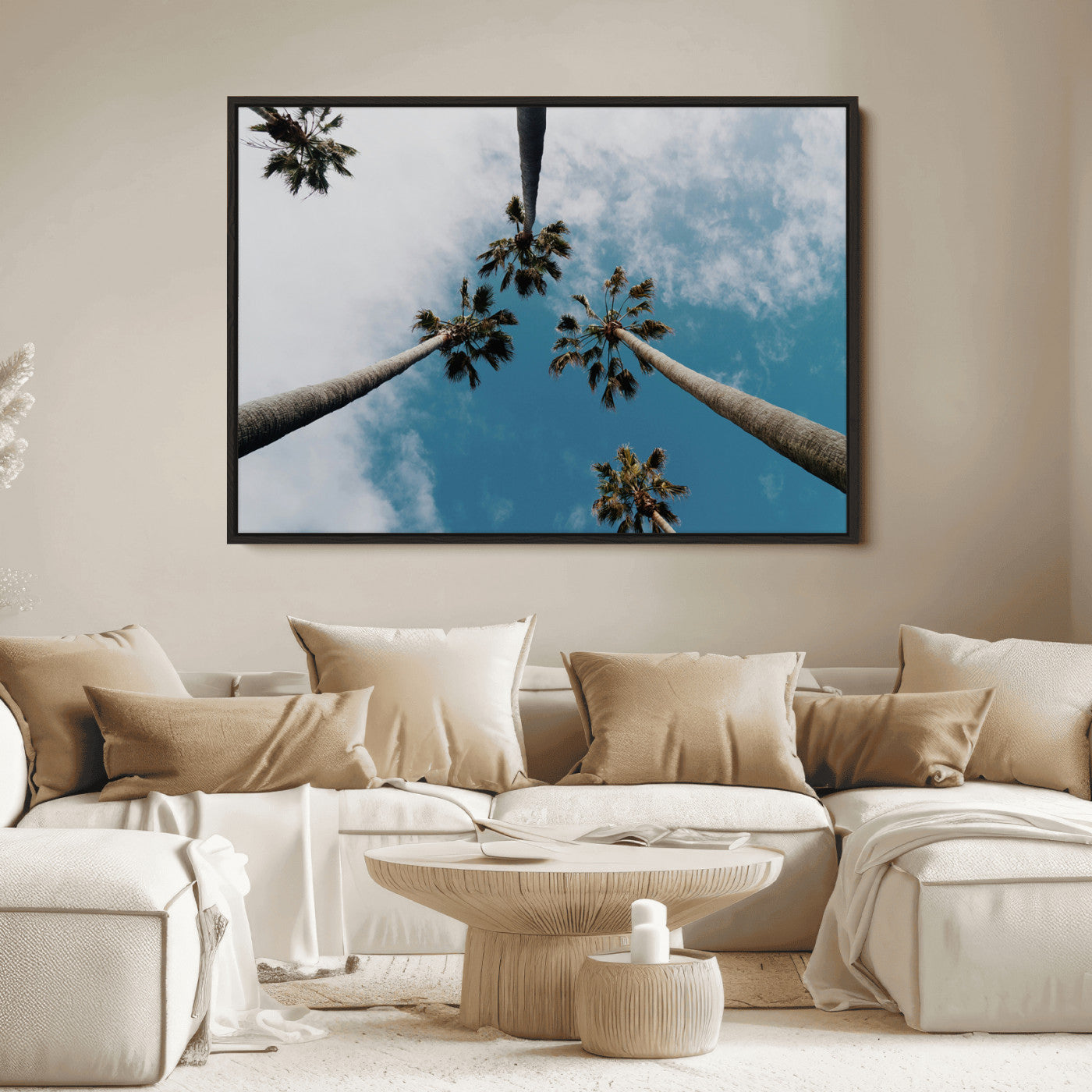 Looking up at tall palm trees against a bright blue sky with scattered clouds, creating a tropical and airy atmosphere for modern home decor.