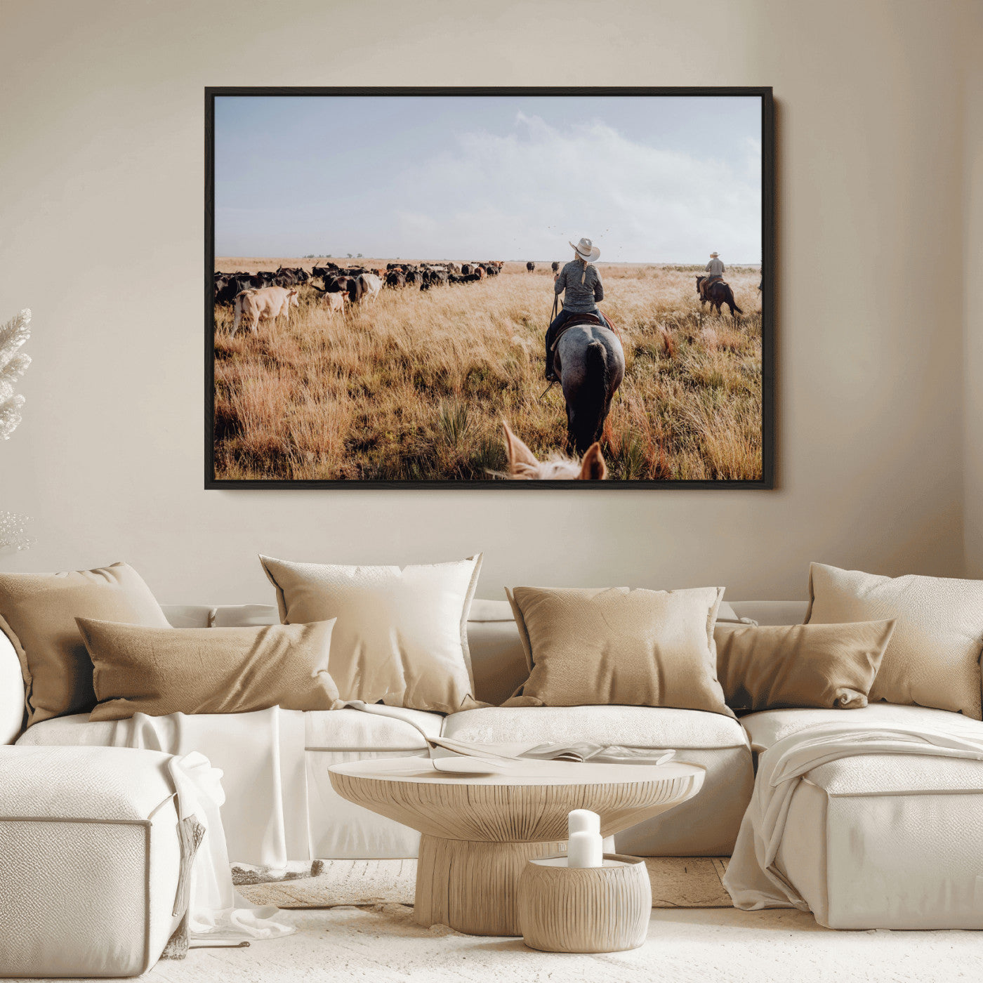 A cowboy and cowgirl on horseback herding cattle through golden grasslands, capturing a rustic and authentic Western ranch lifestyle.