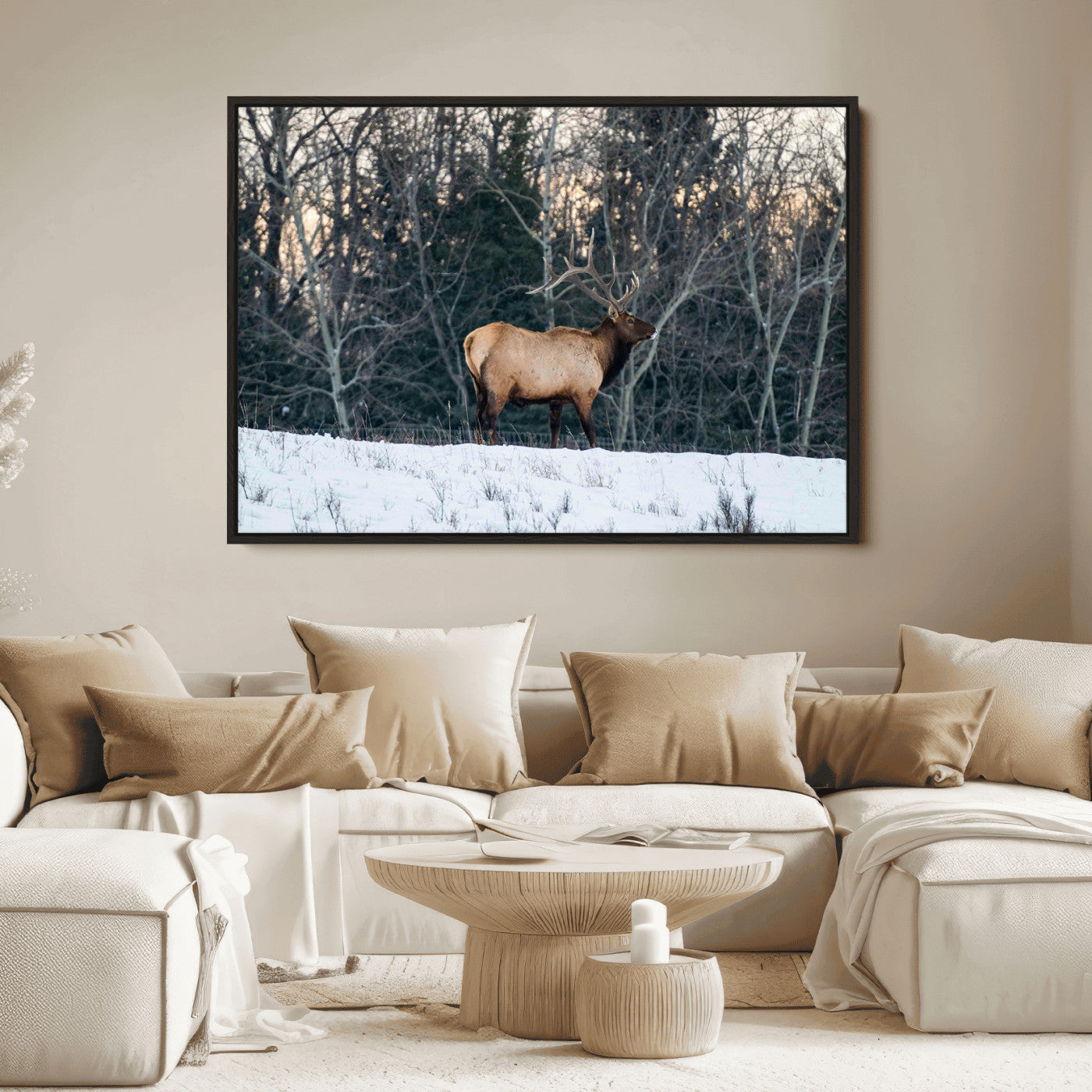 A majestic elk with large antlers standing in a snowy field against a winter forest backdrop, perfect for rustic and wildlife-themed home decor.