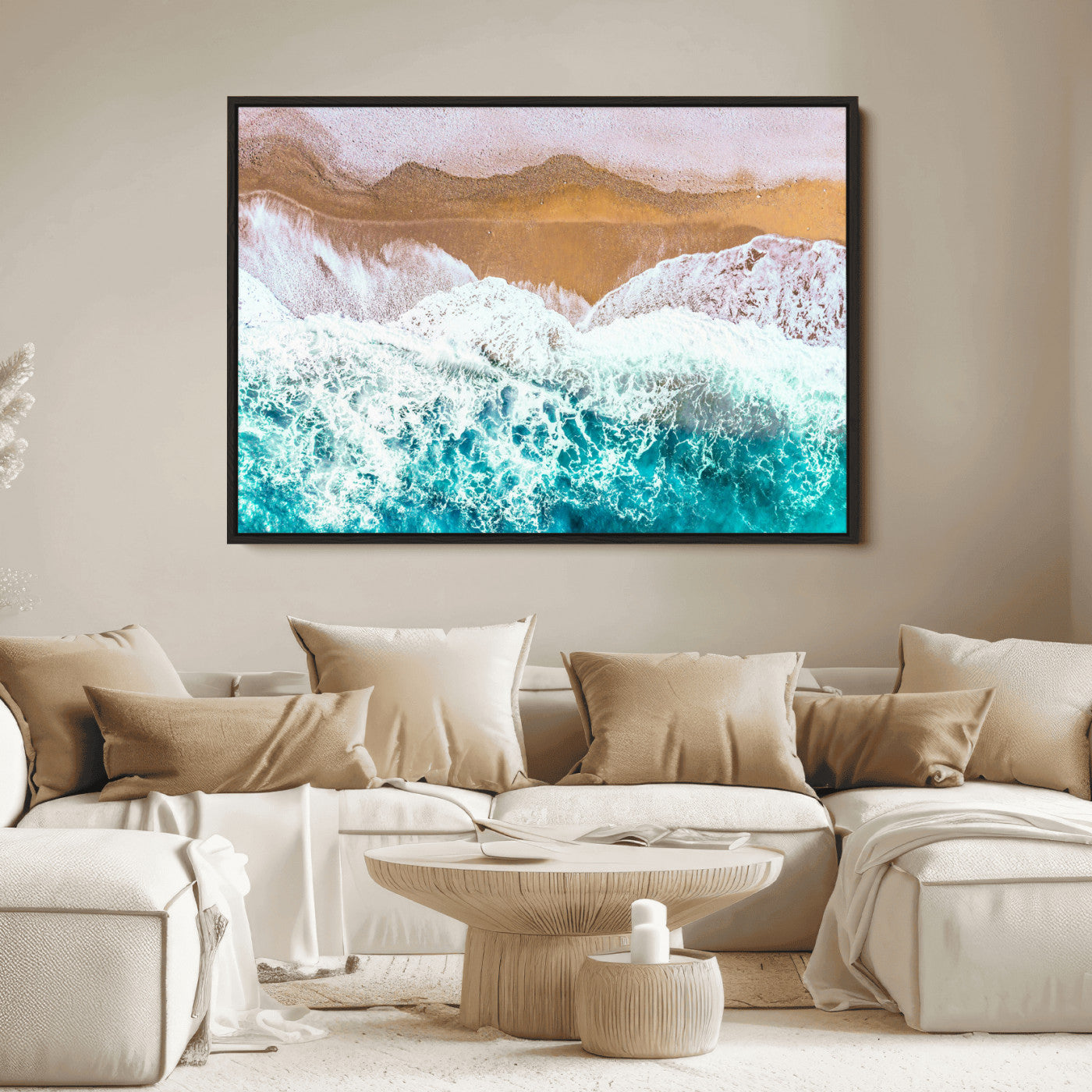 Aerial view of ocean waves crashing onto a sandy beach, with turquoise water and foamy white surf, creating a serene coastal aesthetic for home decor.