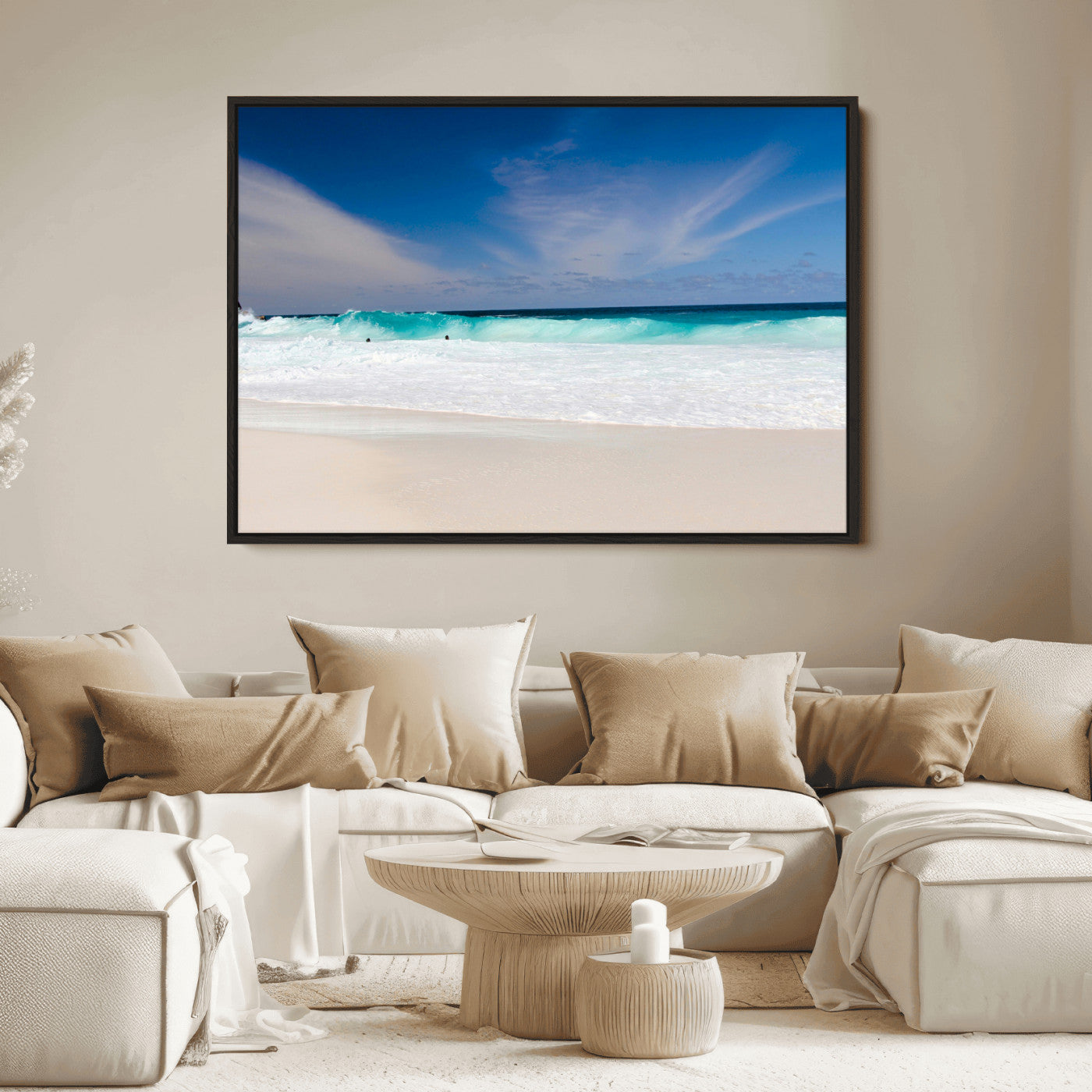 Turquoise waves crash onto a pristine white sand beach under a vivid blue sky with wispy clouds, creating a peaceful and refreshing coastal scene.