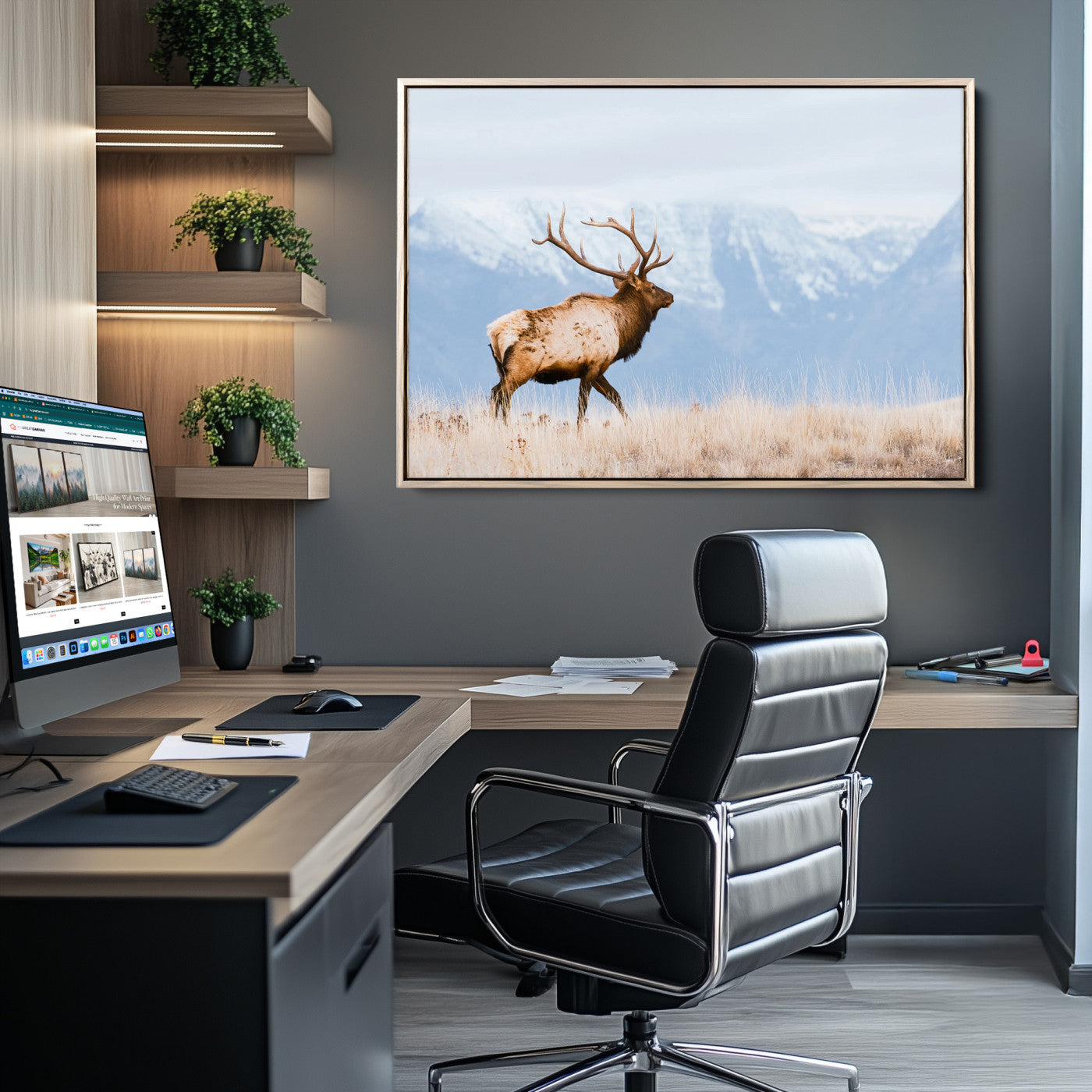 An elk walking on snowy grassland with majestic mountains in the background, ideal for rustic lodge or cabin wall decor.