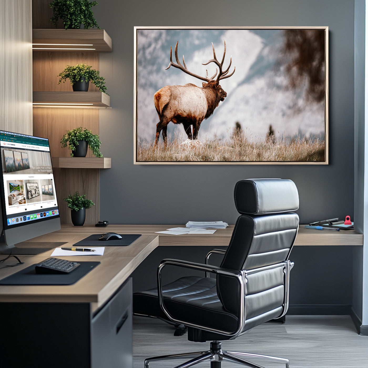 Majestic elk with large antlers standing in grass with snowy mountains in background, perfect for rustic cabin or lodge style decor.