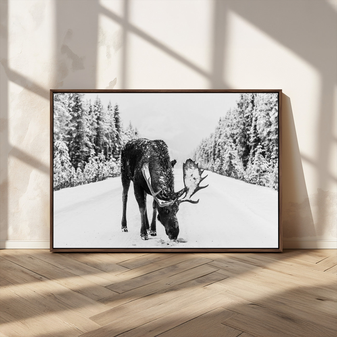 A majestic moose grazing in the snow-covered wilderness, surrounded by snow-covered trees, creating a peaceful winter scene.