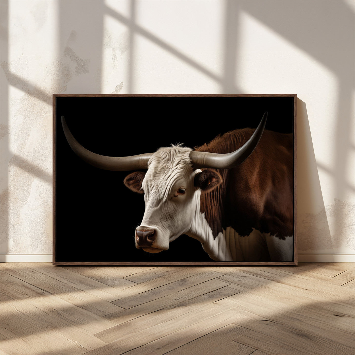 "Close-up of a brown and white longhorn cow with prominent curved horns against a black background."