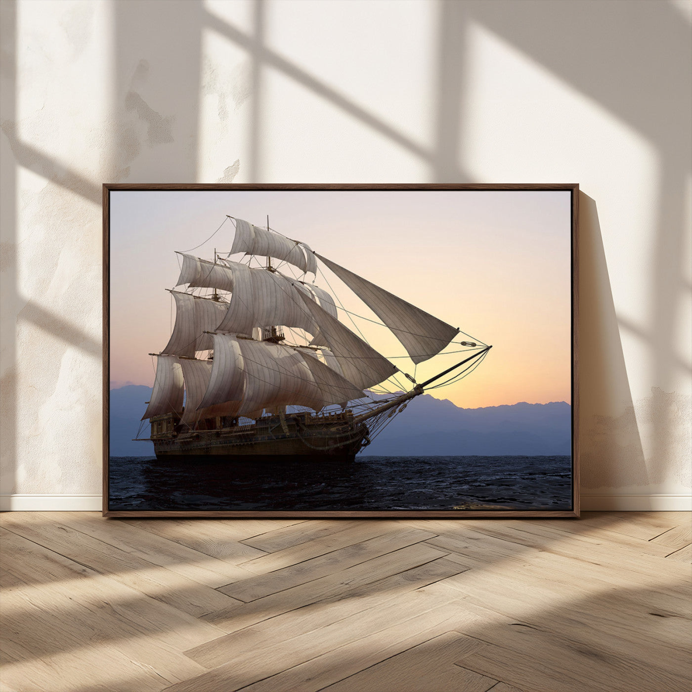 Majestic tall ship with full sails gliding across the ocean at sunset, with mountain silhouettes in the background – Wall Art Canvas Print.