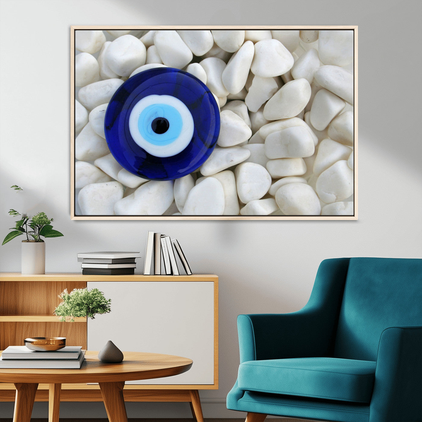 A close-up of a blue evil eye charm placed on white pebbles, symbolizing protection and good luck.