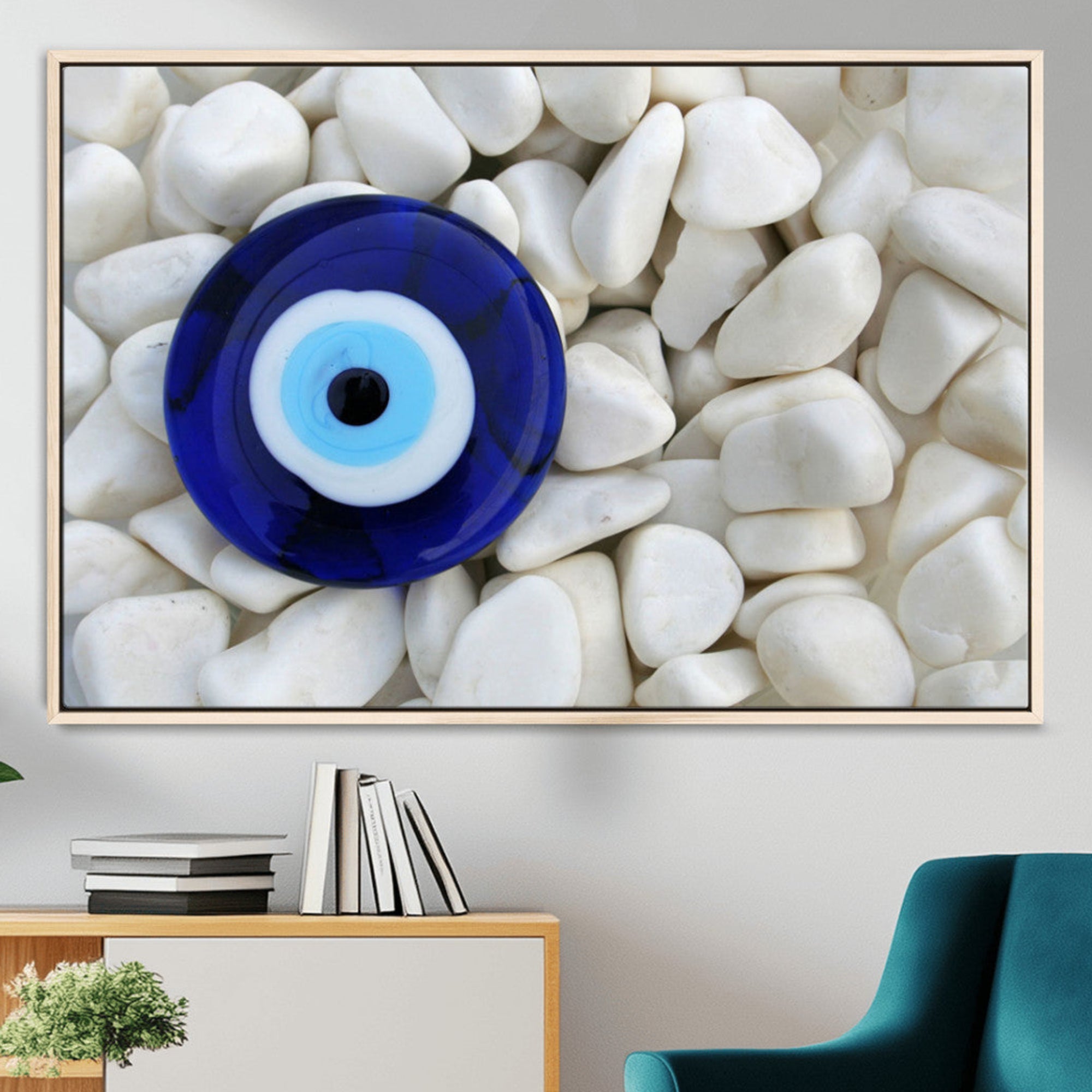 A close-up of a blue evil eye charm placed on white pebbles, symbolizing protection and good luck.