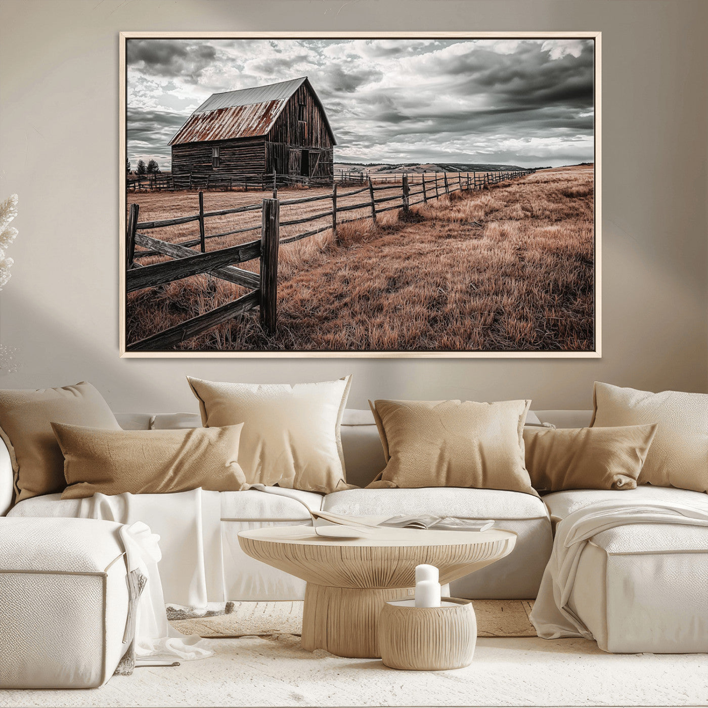 "Black-and-white photograph of a rustic barn with a weathered roof, surrounded by a wooden fence and vast golden fields under a moody sky."