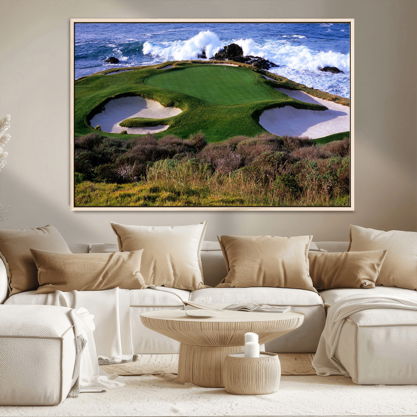 A scenic golf course located by the ocean, featuring a well-manicured green surrounded by sand traps and powerful ocean waves crashing on the shore.