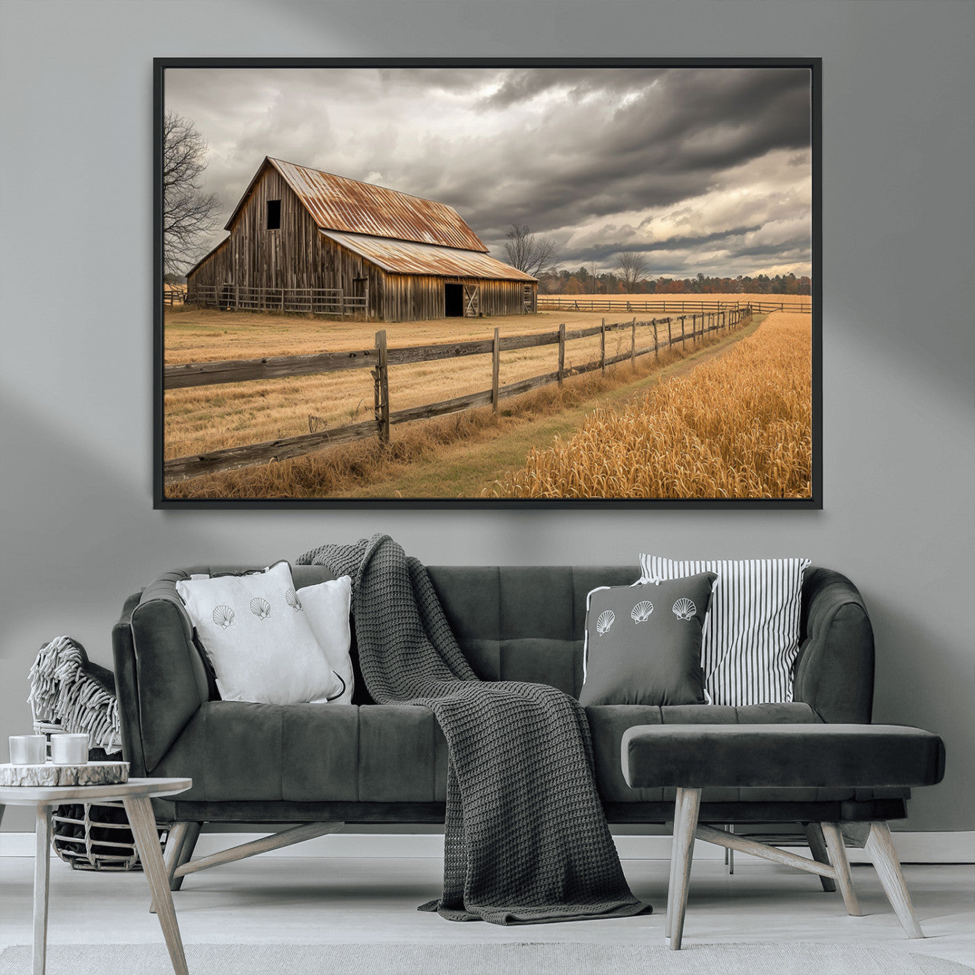 "Rustic barn with a weathered metal roof, surrounded by a wooden fence and golden fields under an overcast sky with dramatic clouds."