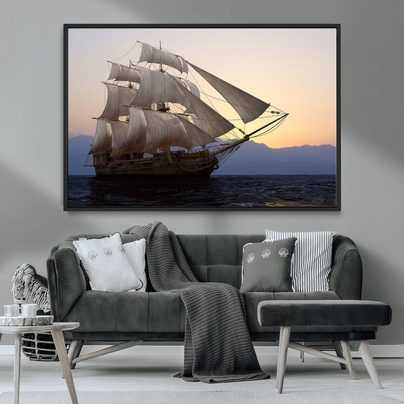 Majestic tall ship with full sails gliding across the ocean at sunset, with mountain silhouettes in the background – Wall Art Canvas Print.