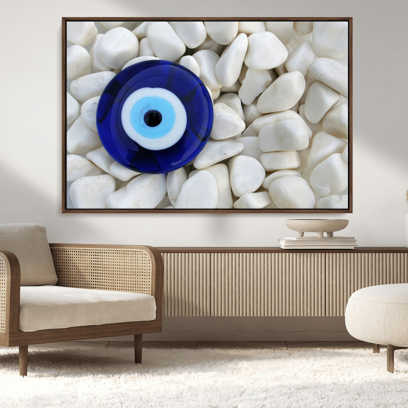 A close-up of a blue evil eye charm placed on white pebbles, symbolizing protection and good luck.