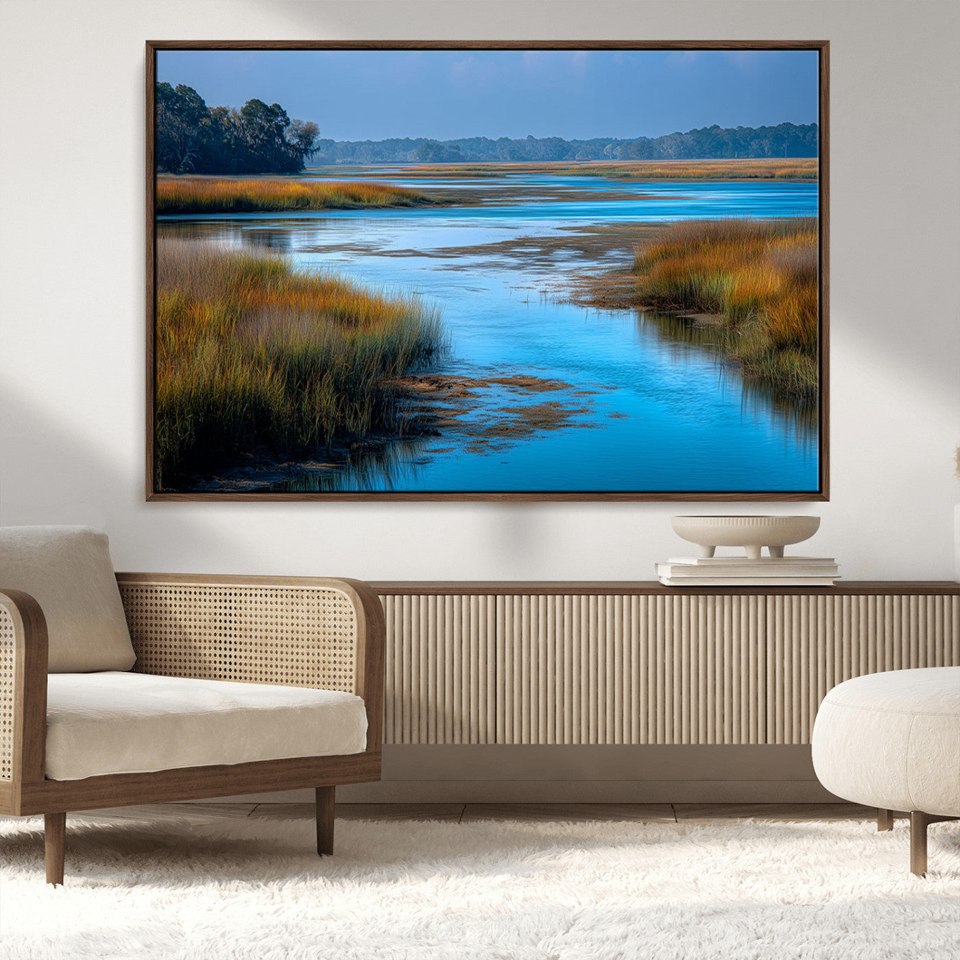 A peaceful marshland scene with calm blue water reflecting the surrounding grasses and trees, capturing the beauty of nature in a serene landscape.