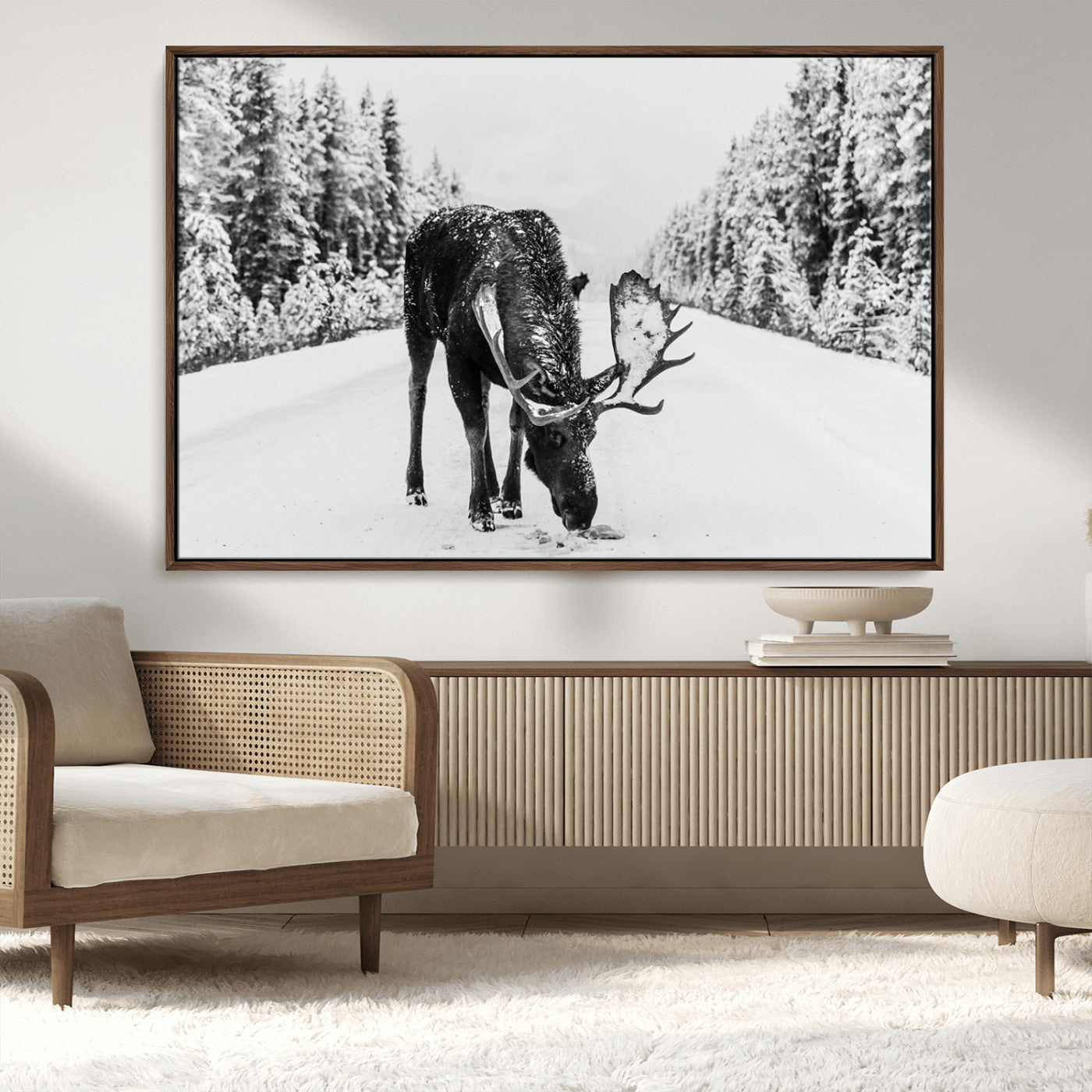 A majestic moose grazing in the snow-covered wilderness, surrounded by snow-covered trees, creating a peaceful winter scene.