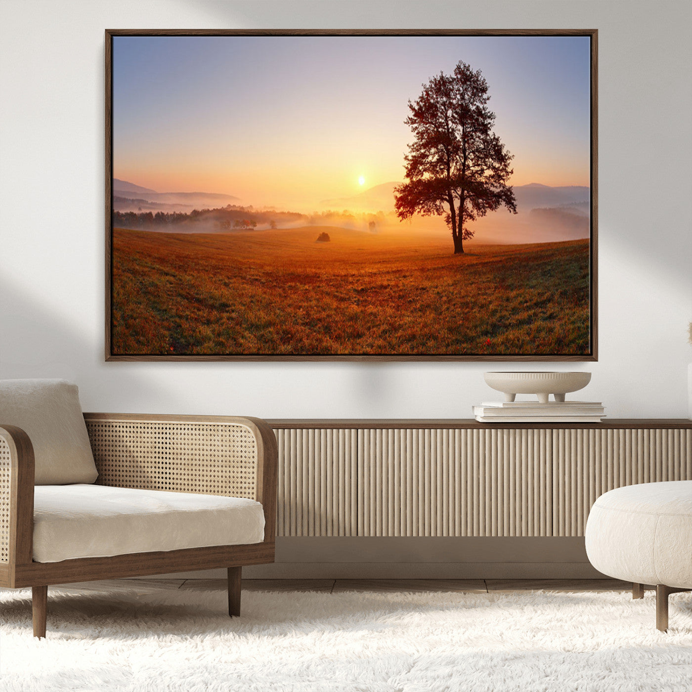 A tranquil landscape at sunrise with a mist-covered field and a lone tree, creating a peaceful and natural atmosphere.