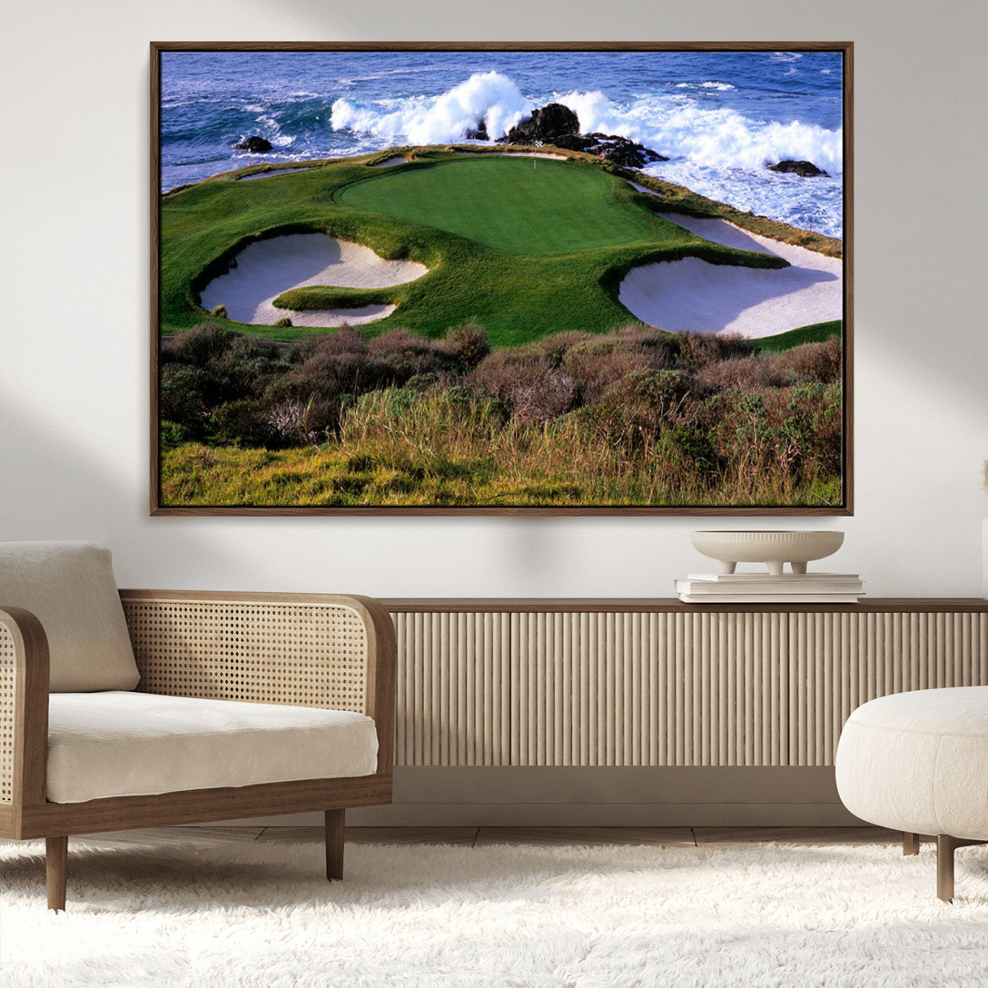 A scenic golf course located by the ocean, featuring a well-manicured green surrounded by sand traps and powerful ocean waves crashing on the shore.
