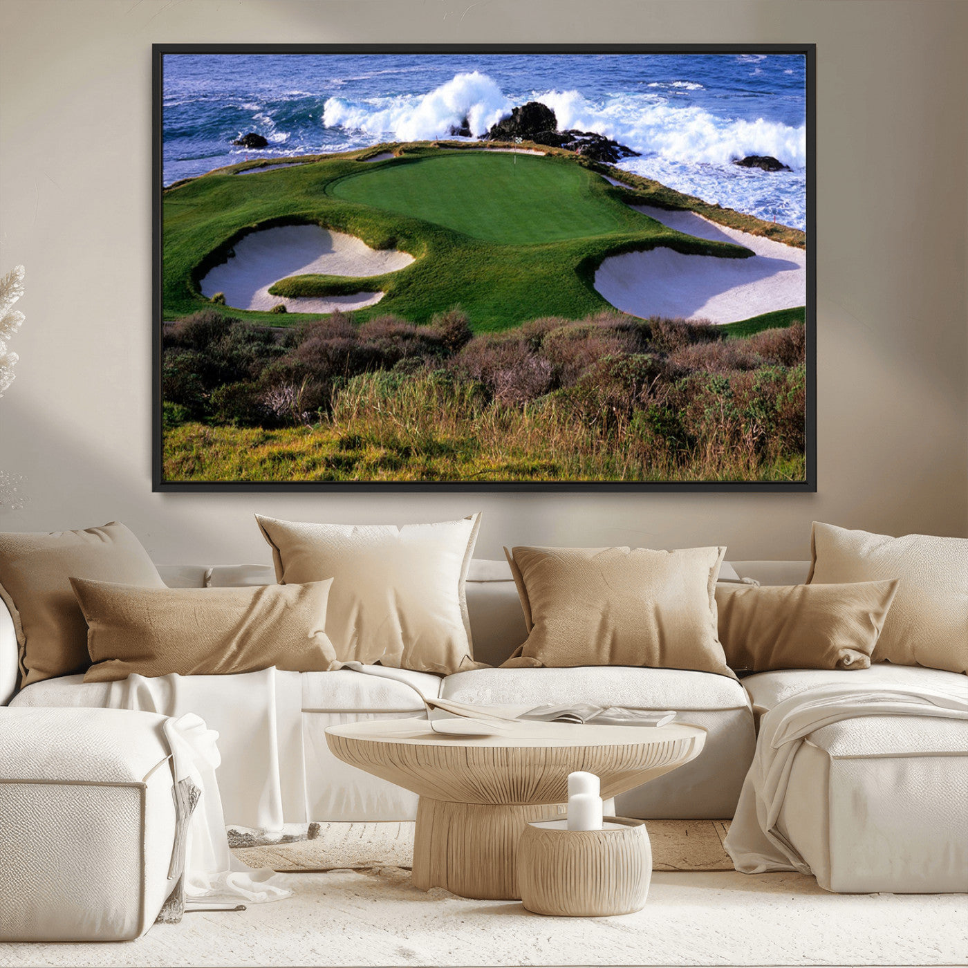A scenic golf course located by the ocean, featuring a well-manicured green surrounded by sand traps and powerful ocean waves crashing on the shore.
