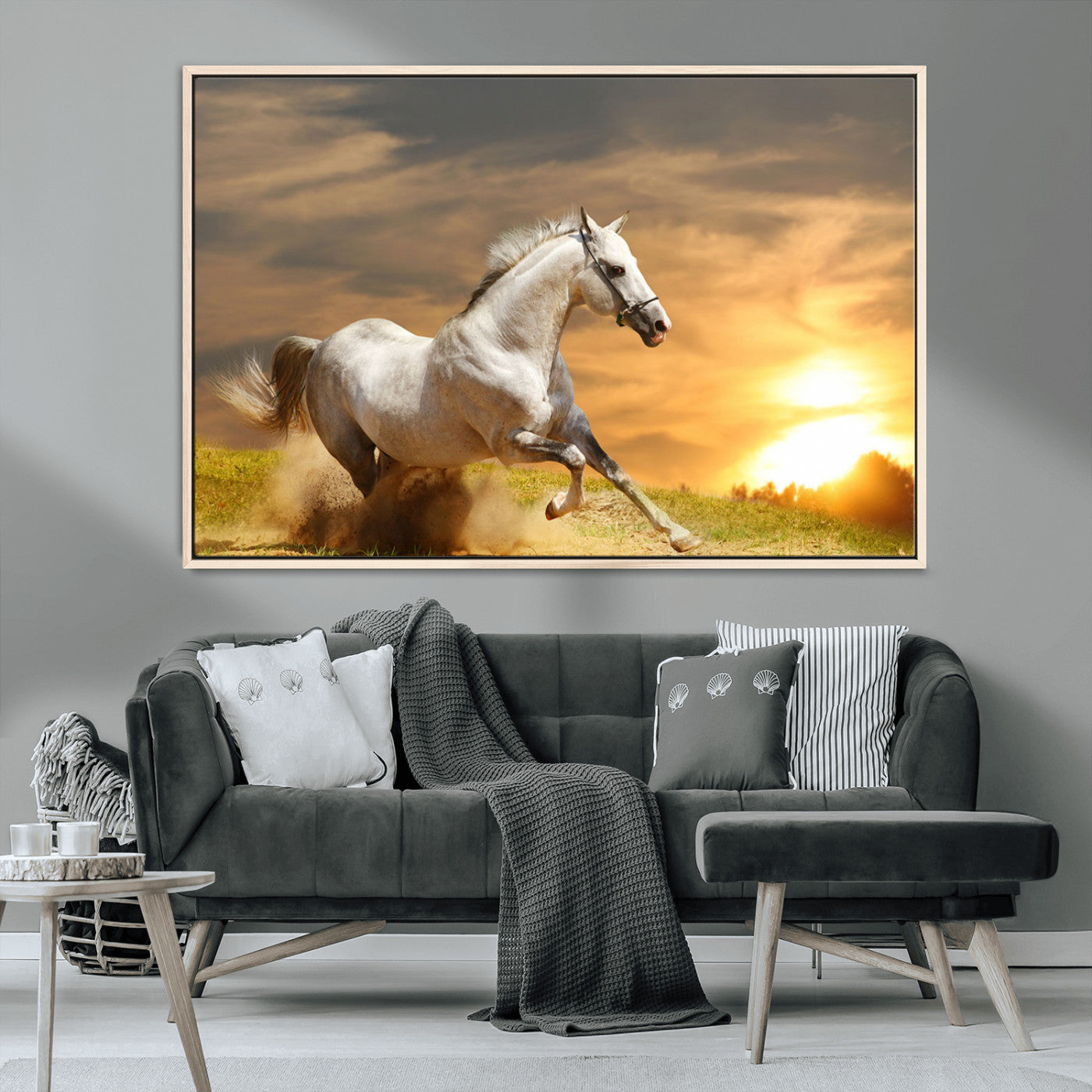 A powerful white horse galloping through the field at sunset, with the golden light illuminating its mane and the vibrant sky in the background.