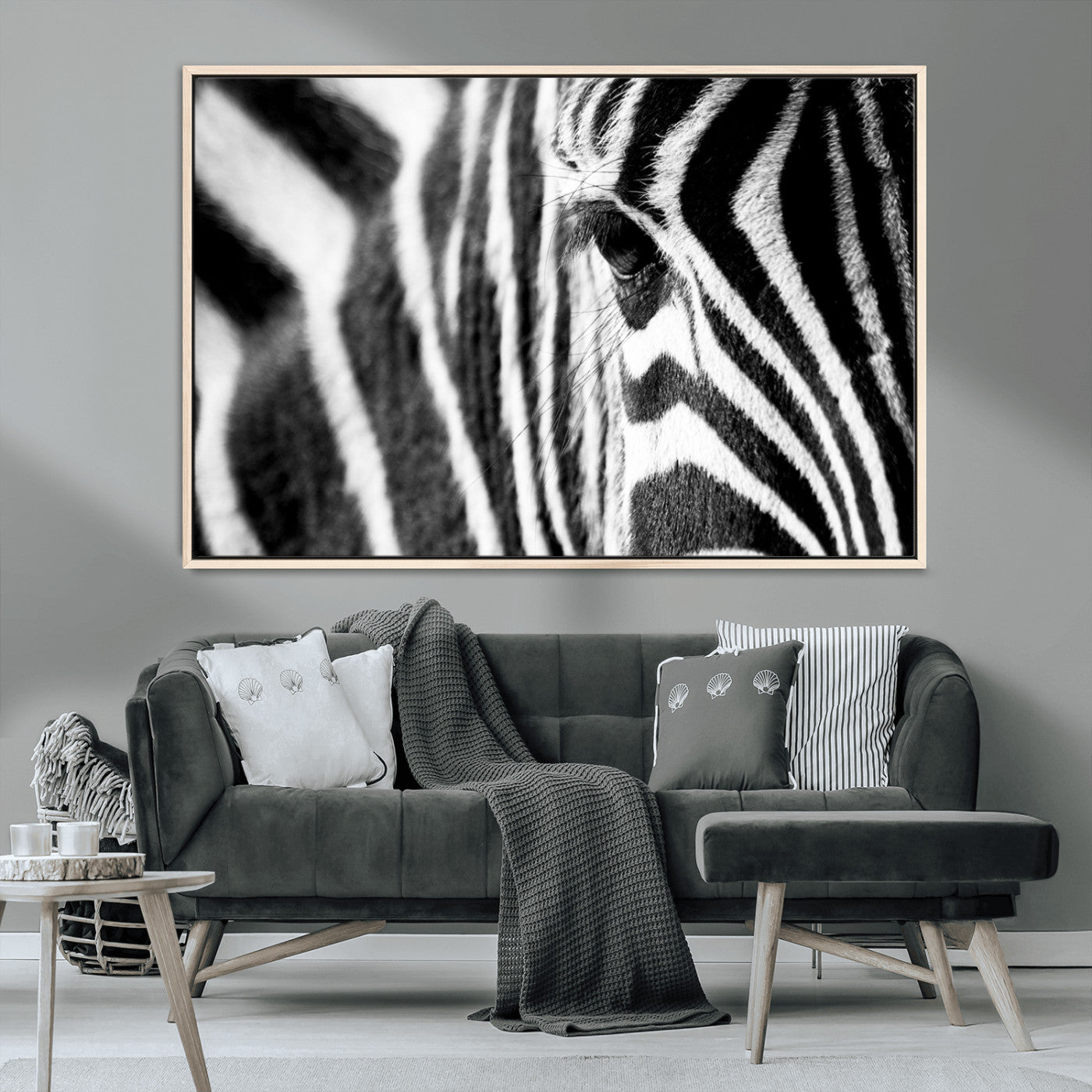 A close-up black and white photograph of a zebra's eye, showcasing the intricate patterns of its stripes in sharp detail.
