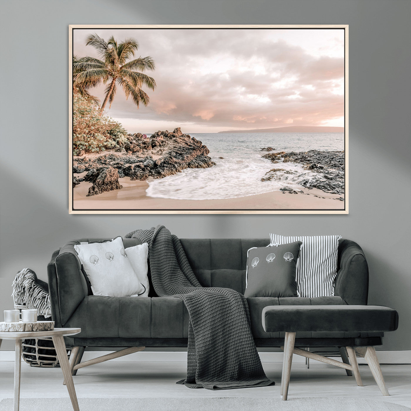 A peaceful beach scene with a palm tree and rocks, soft waves washing onto the shore under a soft pastel sky at sunset.