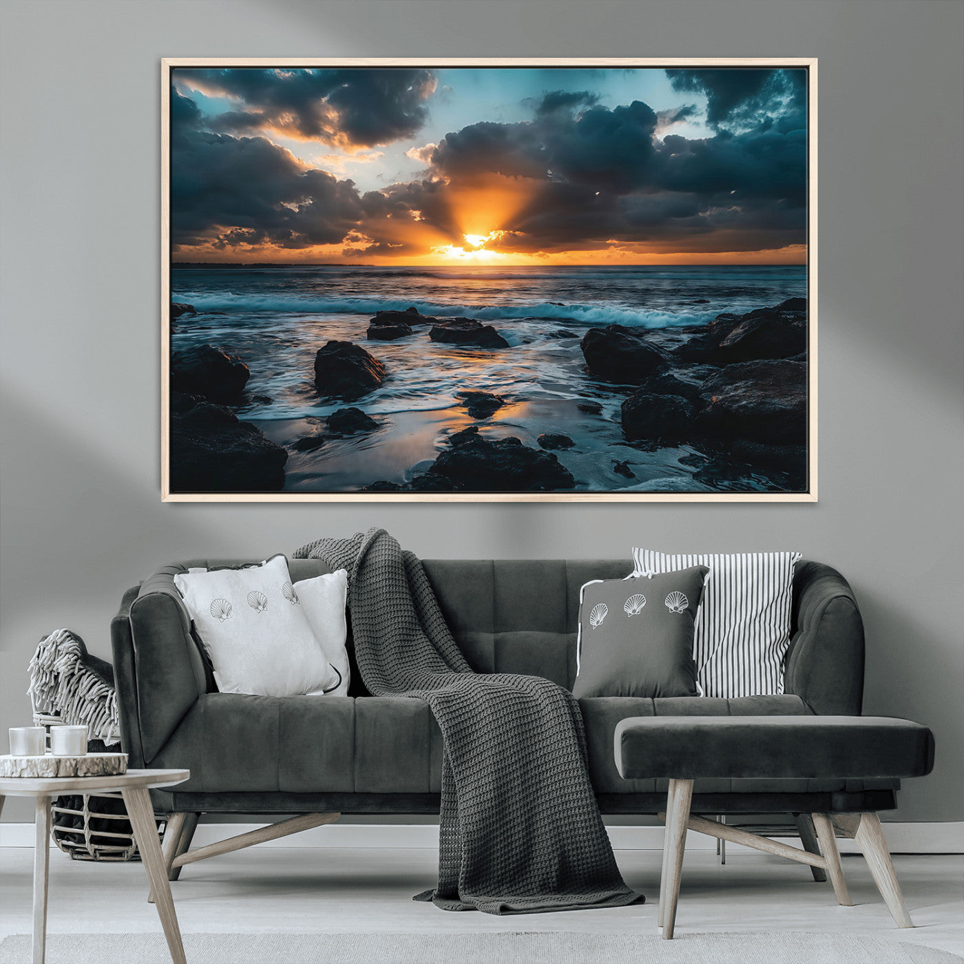 An awe-inspiring sunset over the ocean with rays of light piercing through dramatic clouds, creating a beautiful seascape with rocks in the foreground.