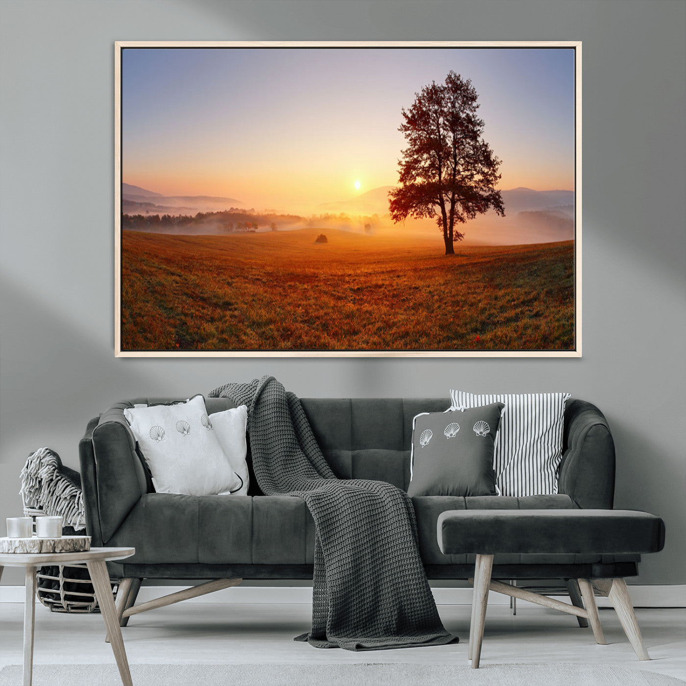 A tranquil landscape at sunrise with a mist-covered field and a lone tree, creating a peaceful and natural atmosphere.