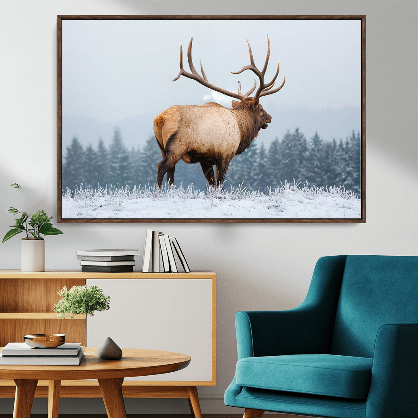 A majestic elk standing in a snowy landscape, with large antlers, set against a backdrop of evergreen trees and a soft winter sky.