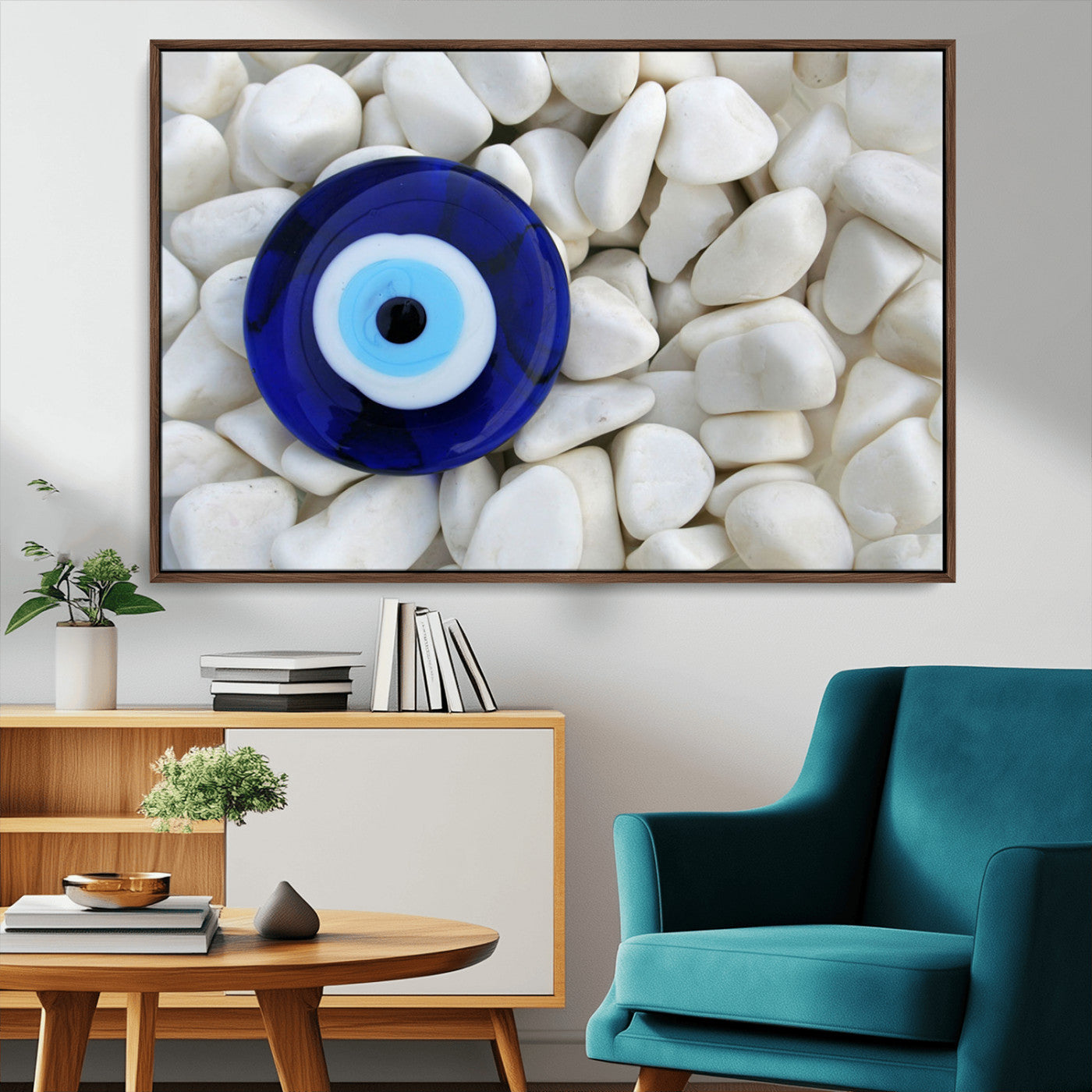 A close-up of a blue evil eye charm placed on white pebbles, symbolizing protection and good luck.
