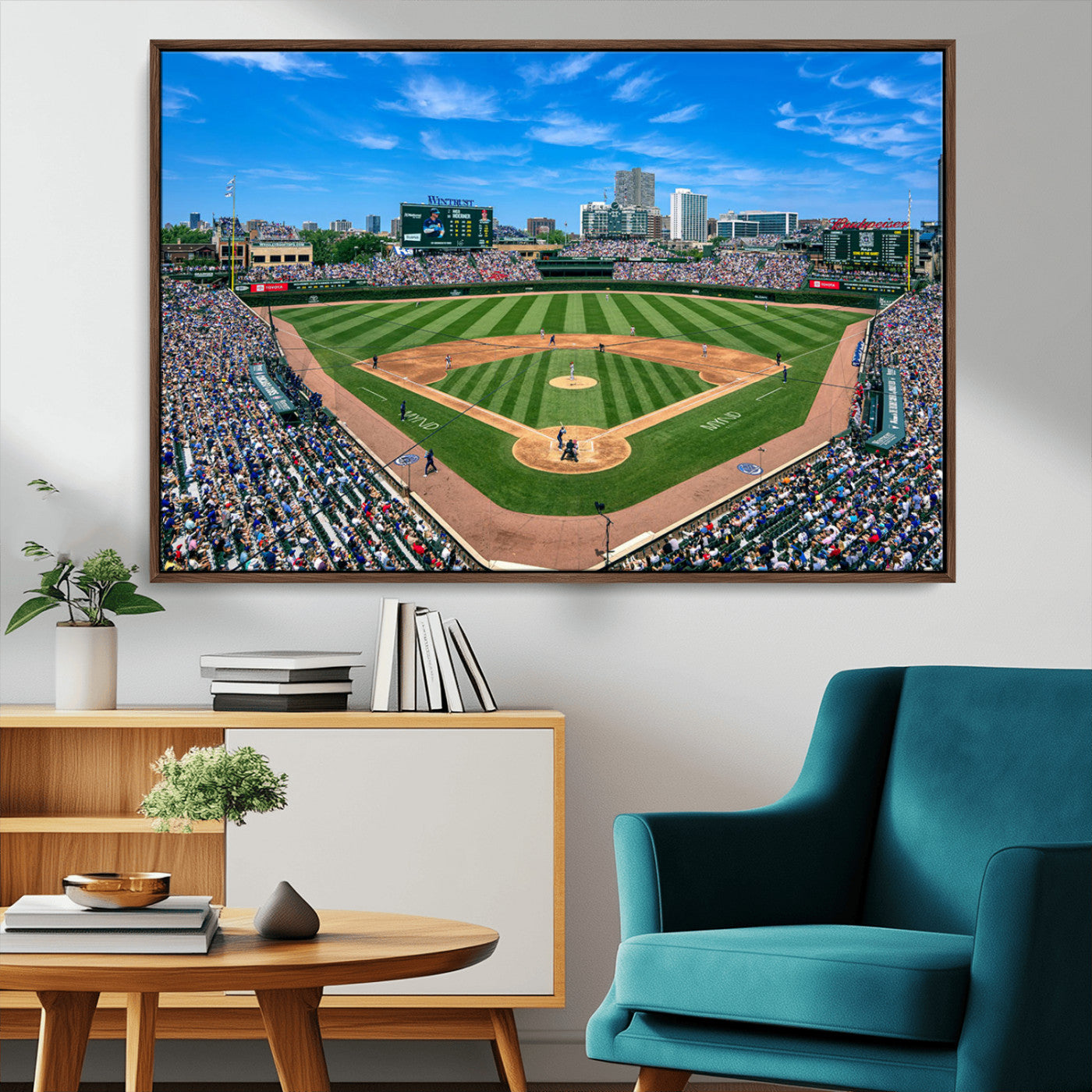 A wide-angle shot of a baseball field filled with spectators, with players on the field and the iconic Wrigley Field scoreboard in the background.