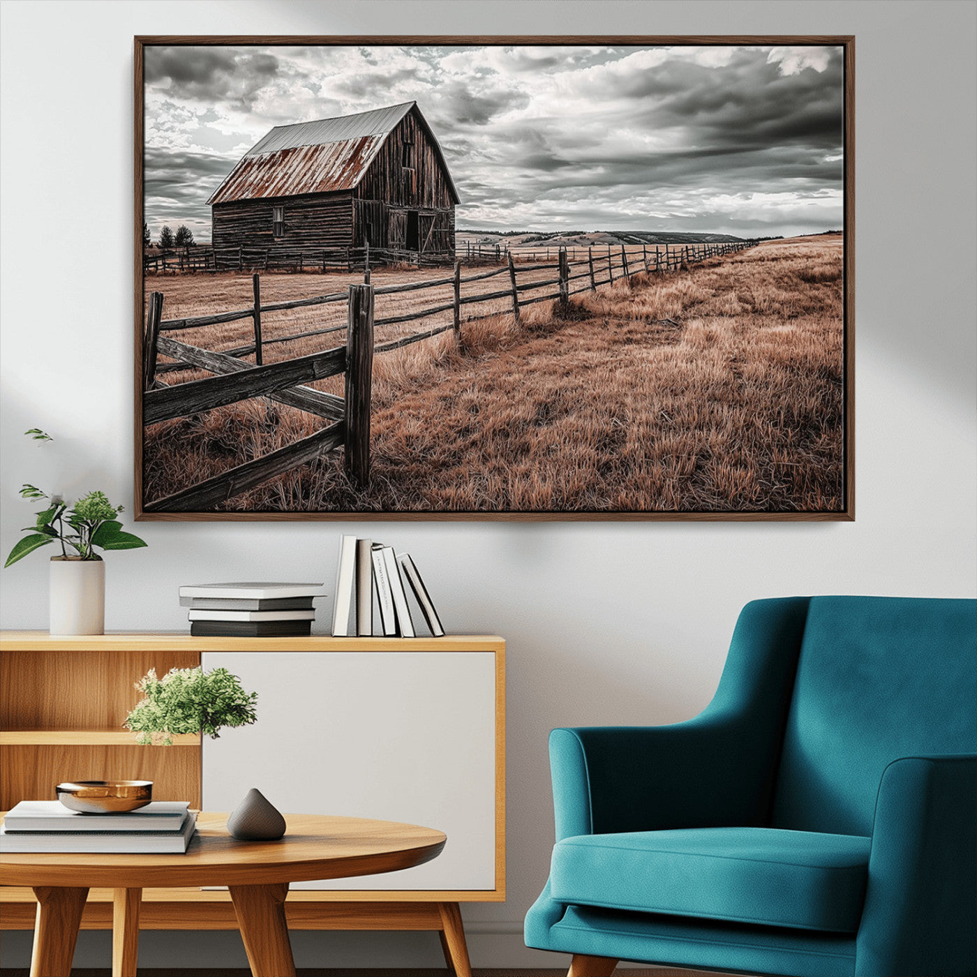 "Black-and-white photograph of a rustic barn with a weathered roof, surrounded by a wooden fence and vast golden fields under a moody sky."