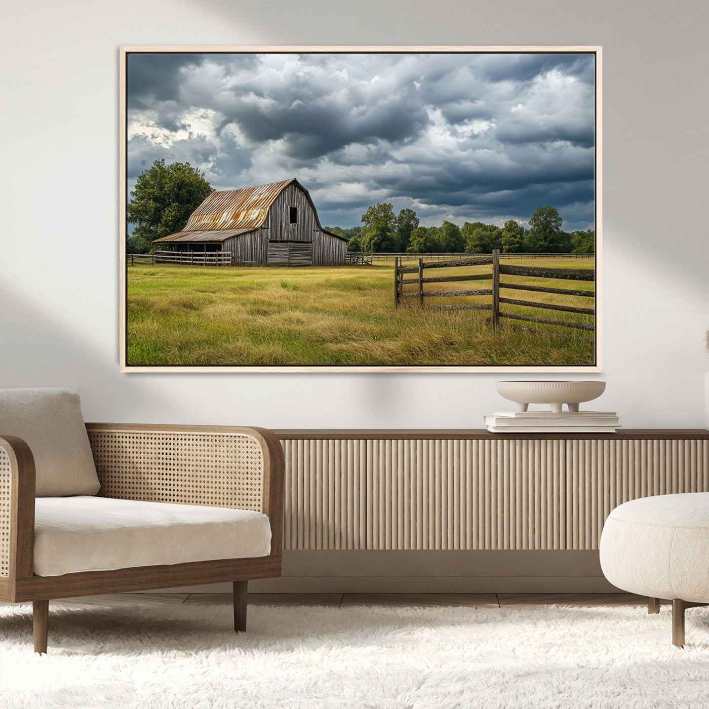 "Rustic barn in a wide open field under a dramatic sky with dark clouds, surrounded by a wooden fence and lush green trees."