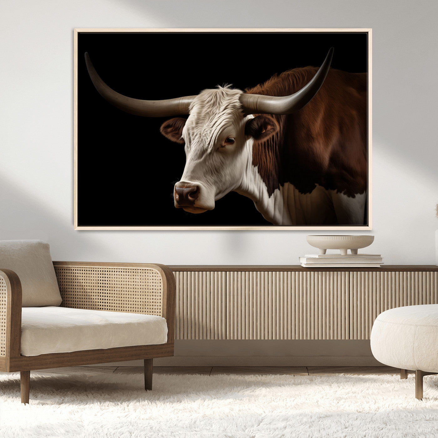 "Close-up of a brown and white longhorn cow with prominent curved horns against a black background."