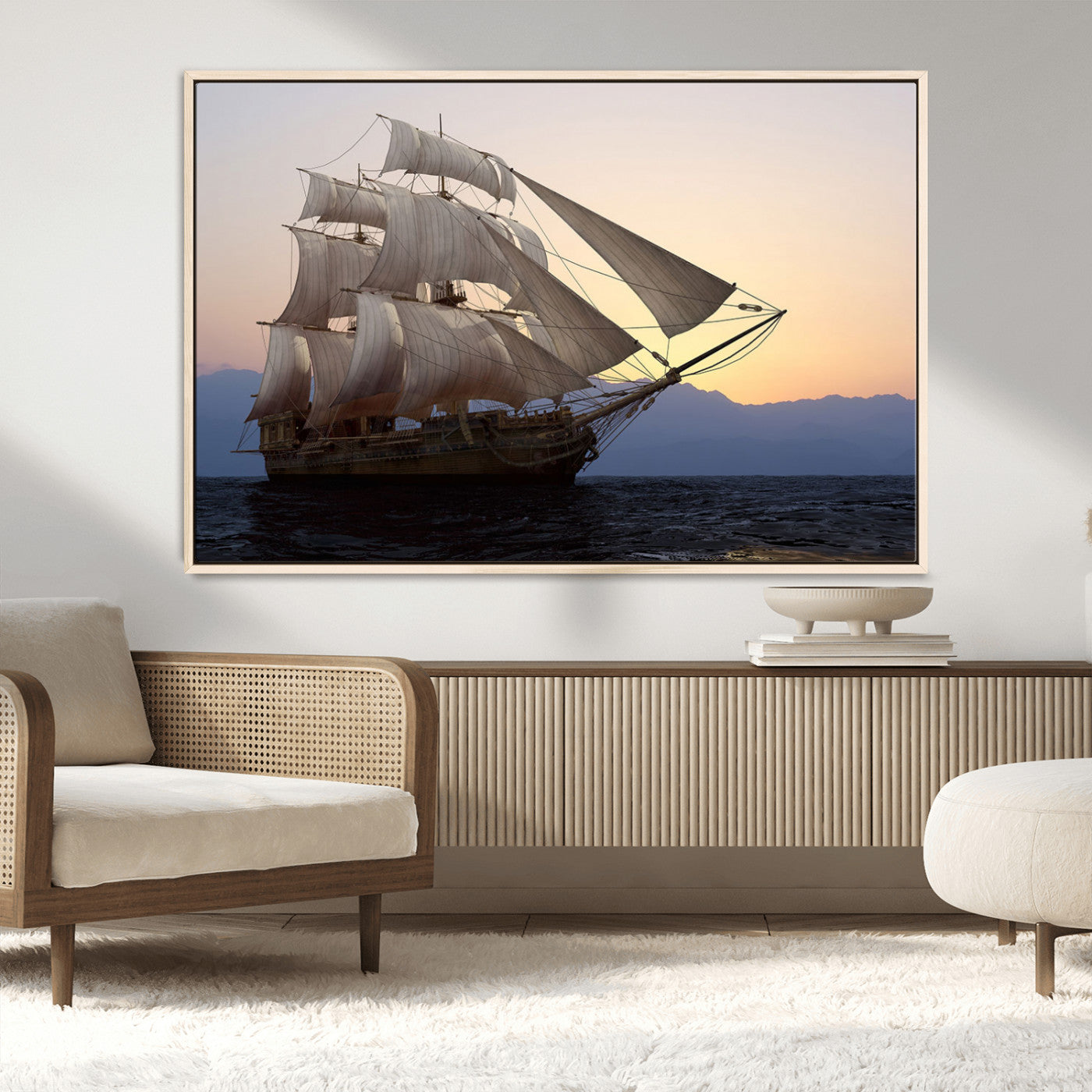 Majestic tall ship with full sails gliding across the ocean at sunset, with mountain silhouettes in the background – Wall Art Canvas Print.