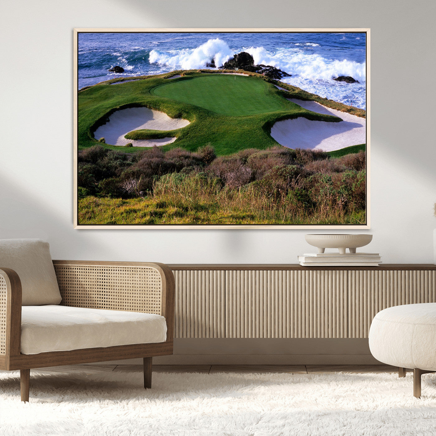 A scenic golf course located by the ocean, featuring a well-manicured green surrounded by sand traps and powerful ocean waves crashing on the shore.