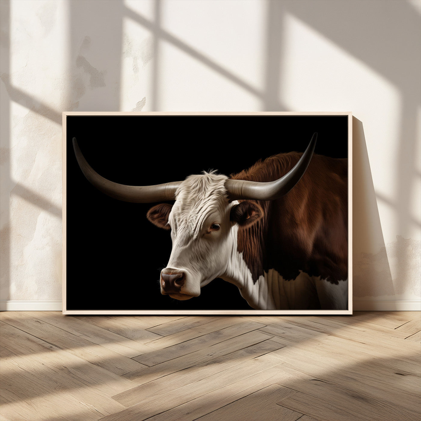 "Close-up of a brown and white longhorn cow with prominent curved horns against a black background."