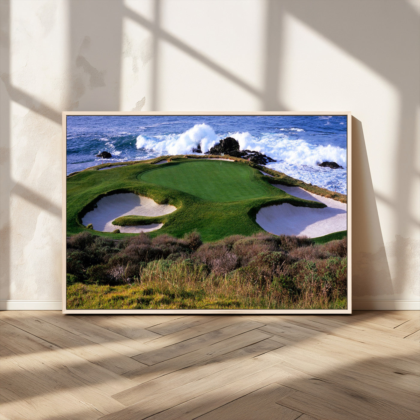 A scenic golf course located by the ocean, featuring a well-manicured green surrounded by sand traps and powerful ocean waves crashing on the shore.