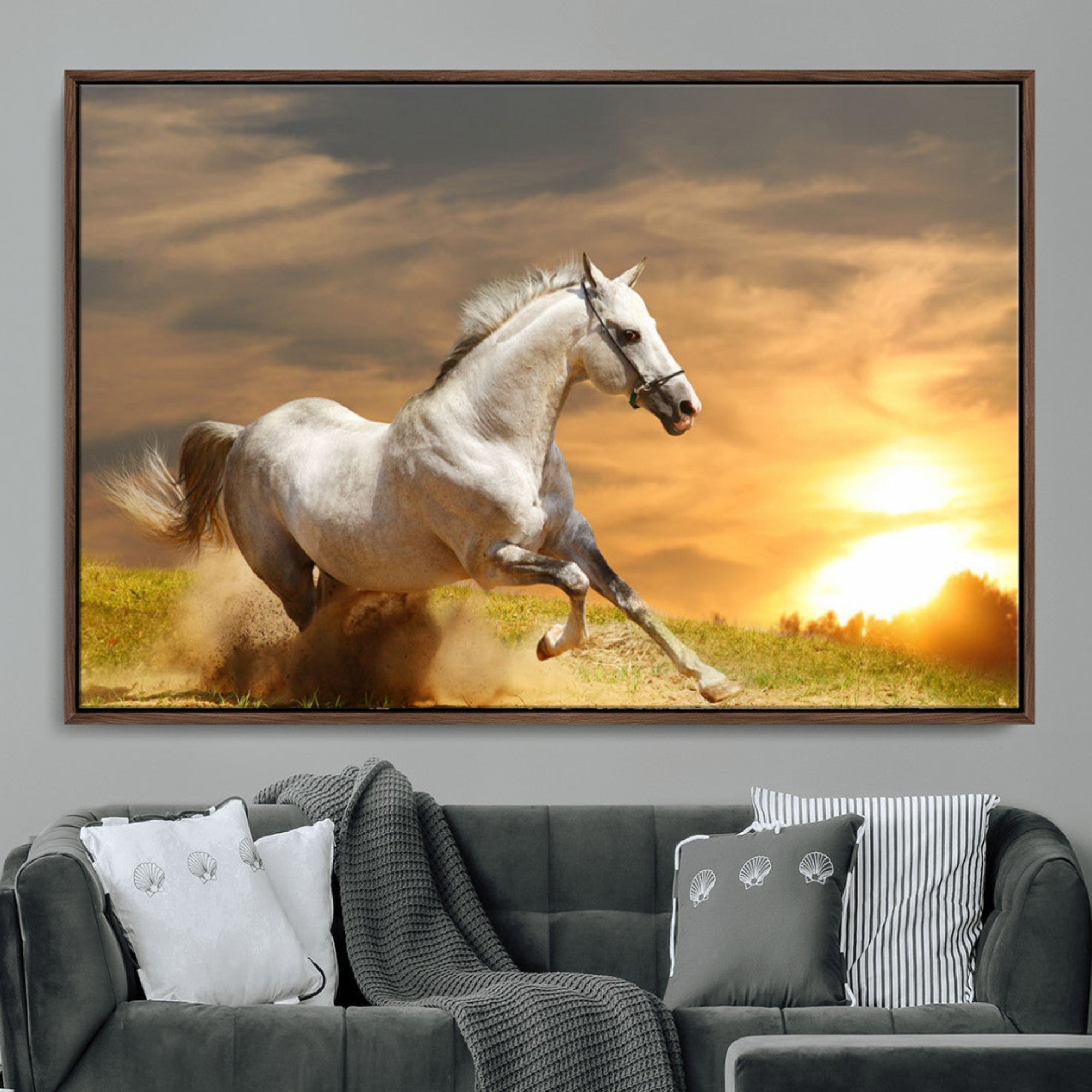 A powerful white horse galloping through the field at sunset, with the golden light illuminating its mane and the vibrant sky in the background.