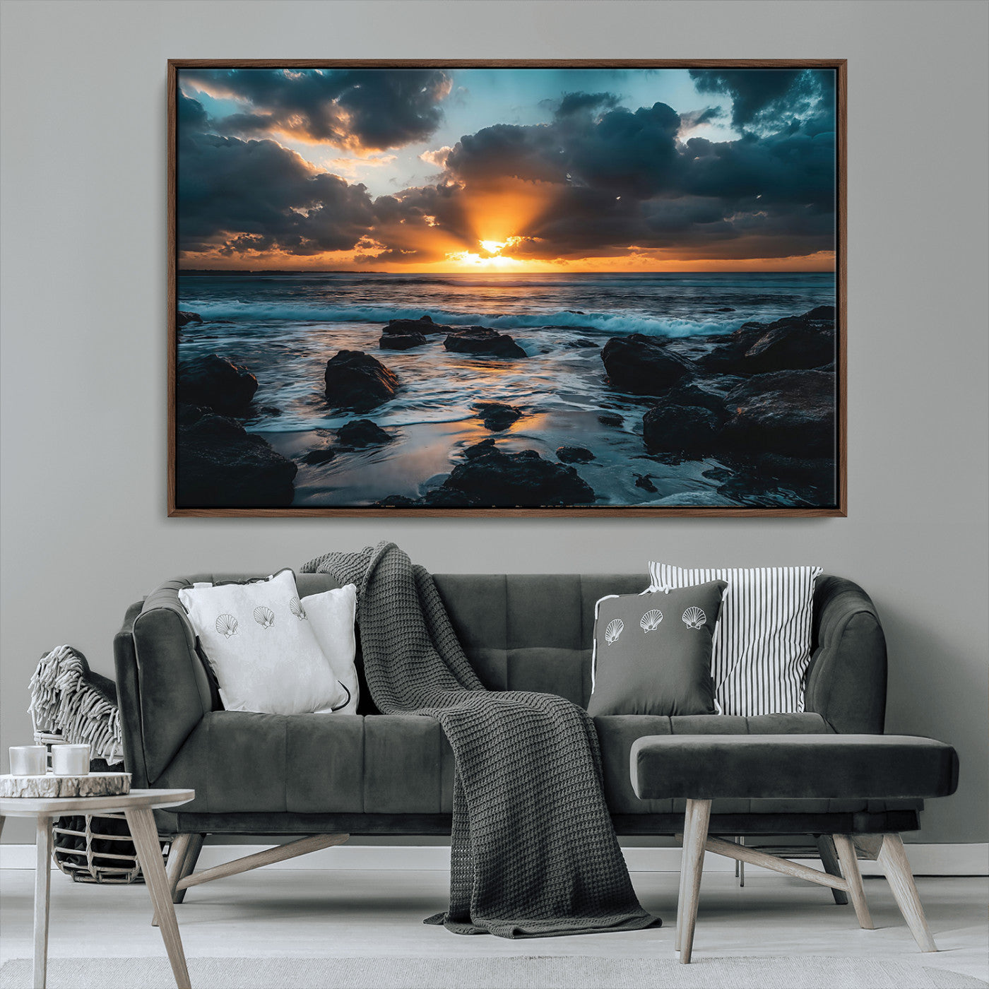 An awe-inspiring sunset over the ocean with rays of light piercing through dramatic clouds, creating a beautiful seascape with rocks in the foreground.