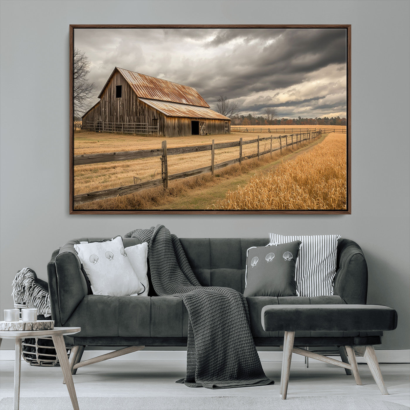 "Rustic barn with a weathered metal roof, surrounded by a wooden fence and golden fields under an overcast sky with dramatic clouds."