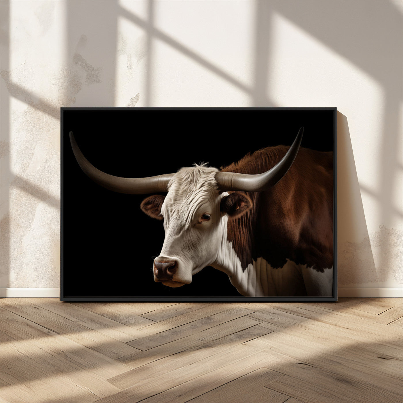 "Close-up of a brown and white longhorn cow with prominent curved horns against a black background."