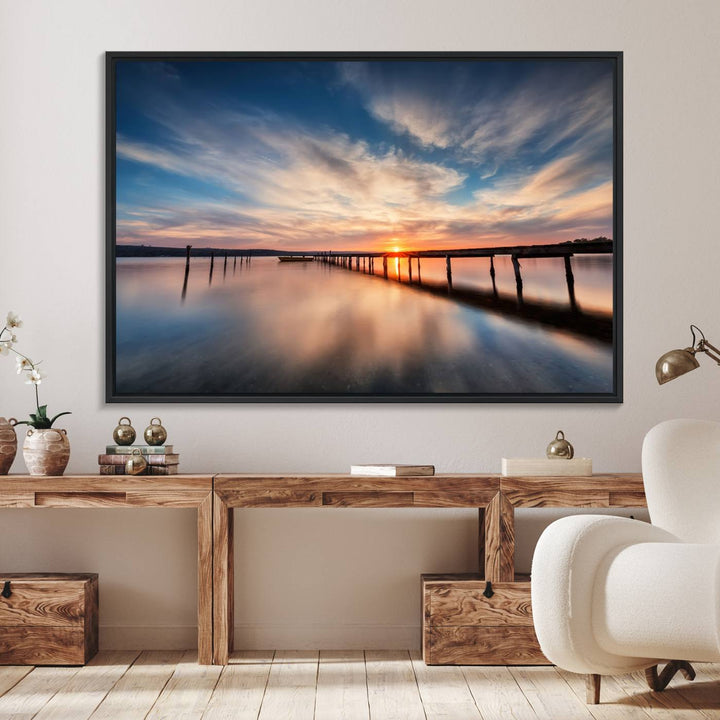 The Sunset Pier Canvas features a serene coastal landscape with vibrant hues under cloudy skies, ideal for modern decor.