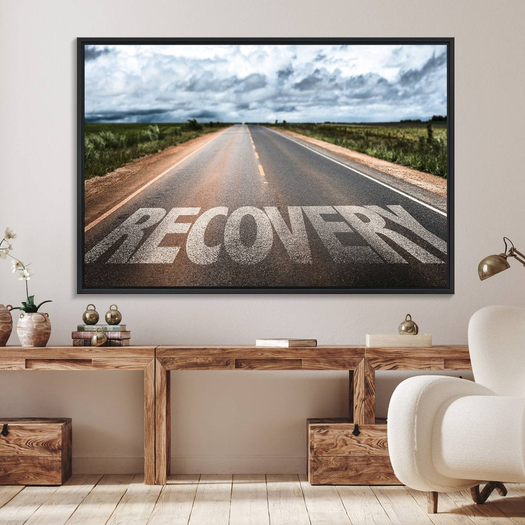 The Recovery Road Wall Art Canvas Print depicts a road under a cloudy horizon.