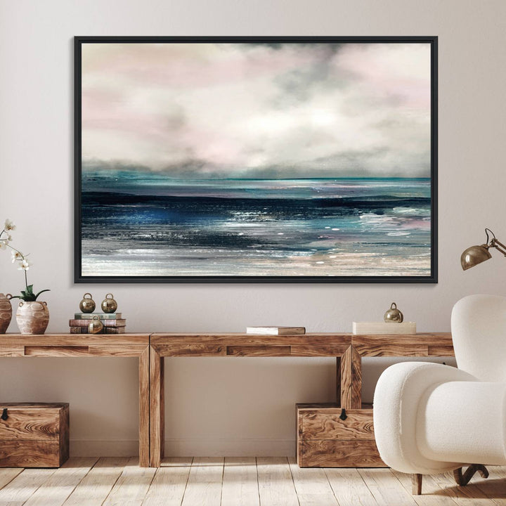 A contemporary abstract wall art canvas print in pastel pink, teal, and gray tones hangs on the wall.