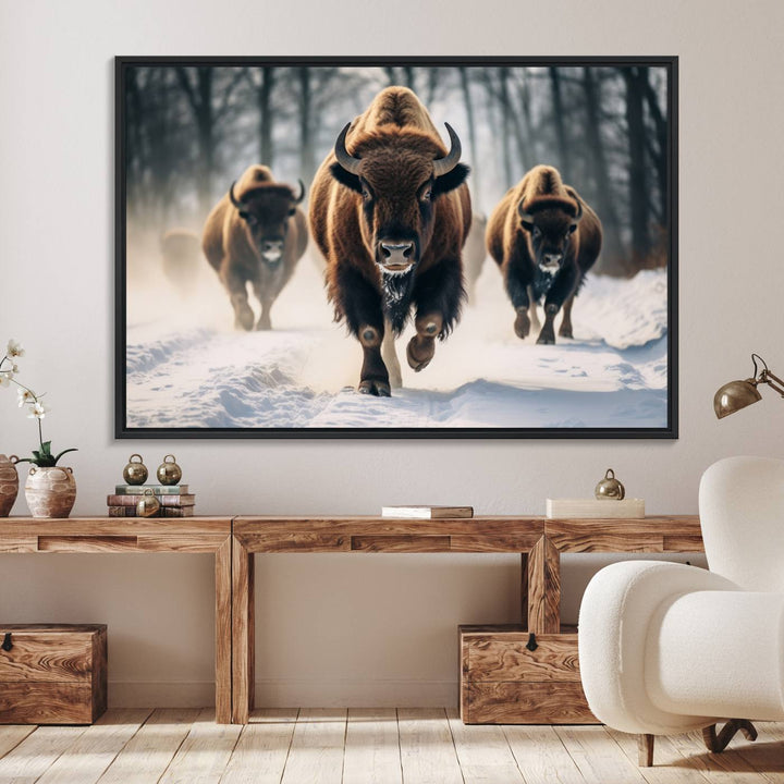 Wall art titled Cow Bighorn shows three bison running through snow in a forest.