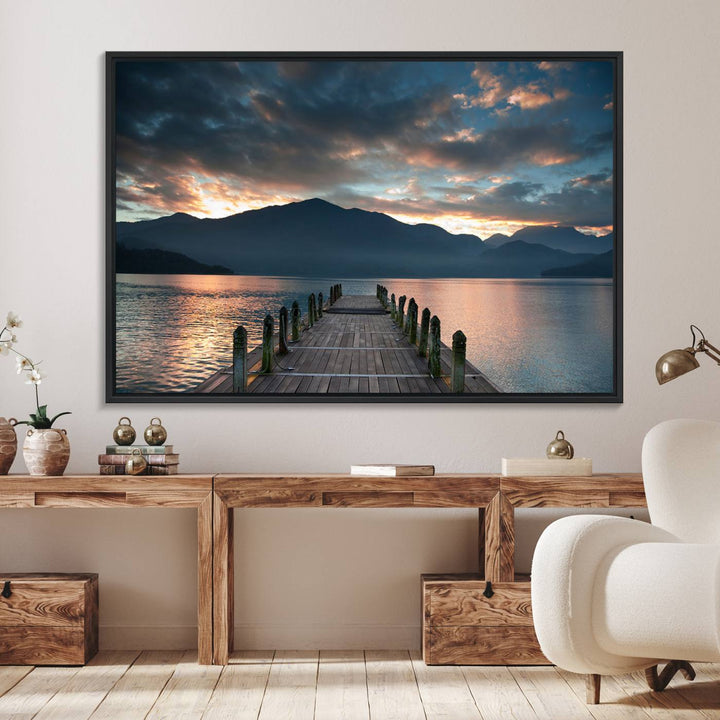 The Mountain Lake Wood Pier Canvas Wall Art depicts a serene lake and mountains, enhancing the beauty of any space.