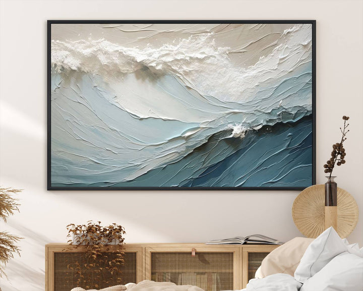 The Waves Abstract Wall Art Print is a large textured painting featuring ocean waves in beige and blue tones. This modern framed abstract canvas print captures the serene essence of seaside tranquility and serves as stunning ready-to-hang wall art, making it perfect as living room decor.